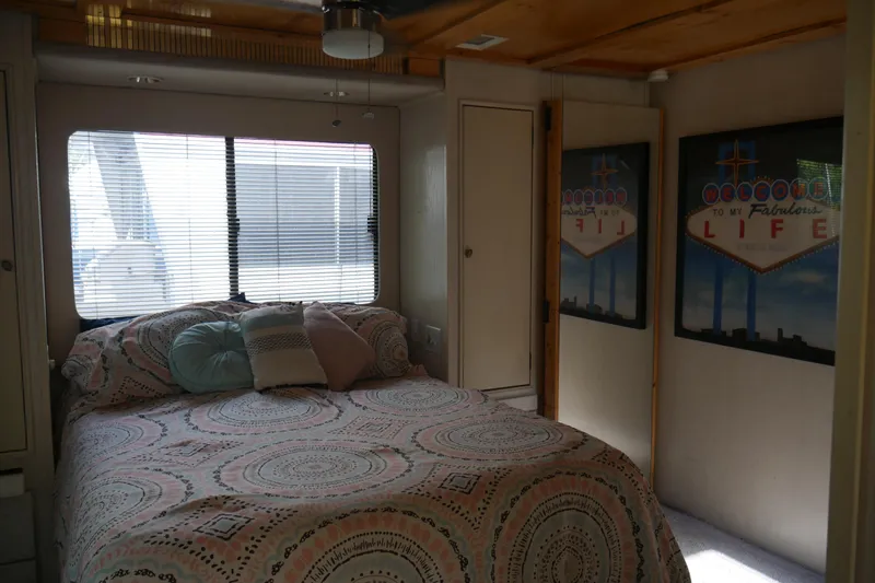  Yacht Photos Pics Cozy bedroom in 1996 STARDUST Cruiser with patterned bedding and decorative wall art.