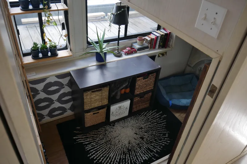  Yacht Photos Pics Cozy interior of 1996 STARDUST Cruiser with plants, books, and decorative storage.