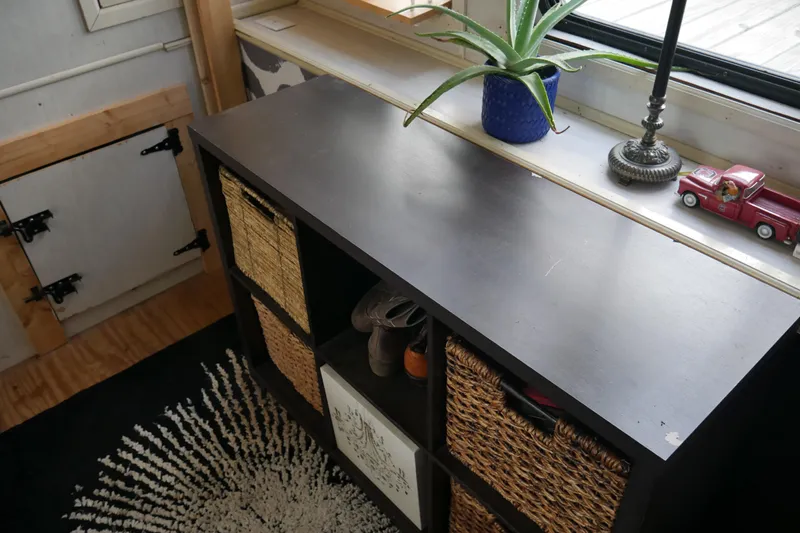  Yacht Photos Pics Wooden cabinet with wicker baskets, aloe plant, lamp, and toy truck on windowsill. STARDUST Cruiser 1996.