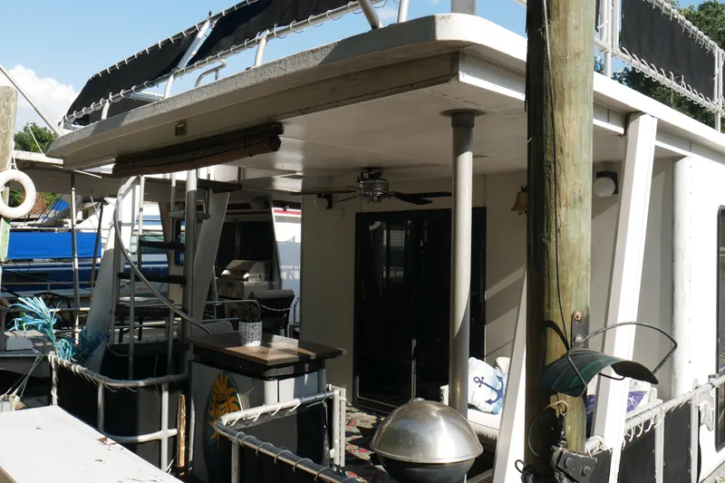  Yacht Photos Pics 1996 STARDUST Cruiser boat docked, featuring outdoor seating and nautical decor.