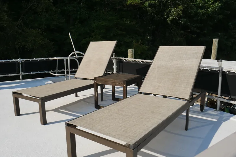  Yacht Photos Pics Two lounge chairs and a table on a 1996 STARDUST Cruiser deck.