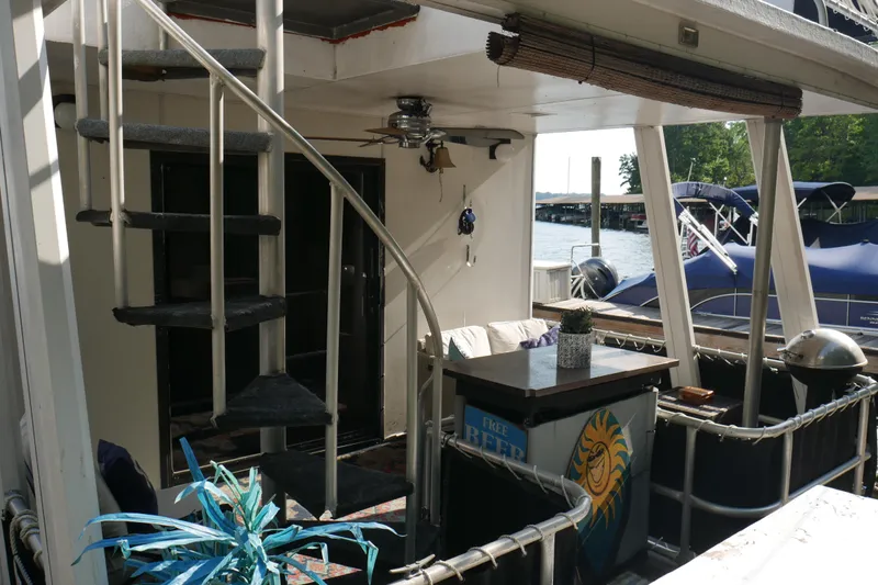  Yacht Photos Pics 1996 STARDUST Cruiser boat interior with spiral staircase and outdoor seating area.