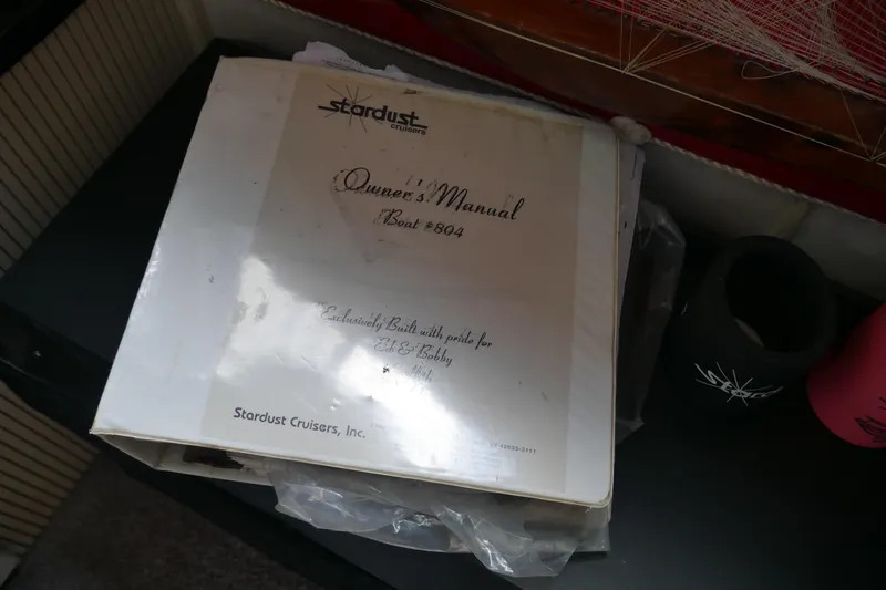  Yacht Photos Pics Owner's manual for 1996 Stardust Cruiser boat, model #804, on a table.