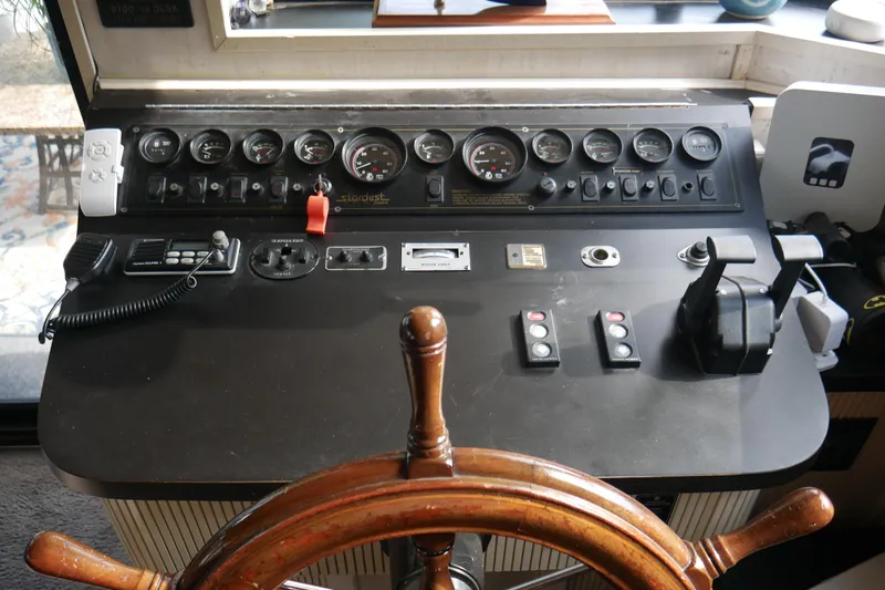  Yacht Photos Pics Control panel of a 1996 STARDUST Cruiser boat with gauges and steering wheel.