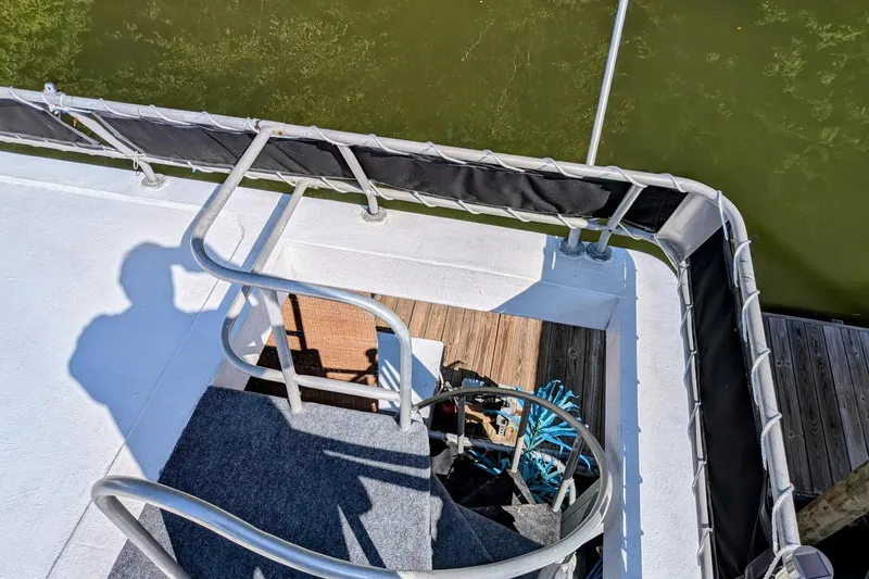  Yacht Photos Pics Staircase on 1996 Stardust Cruisers boat, overlooking green water.