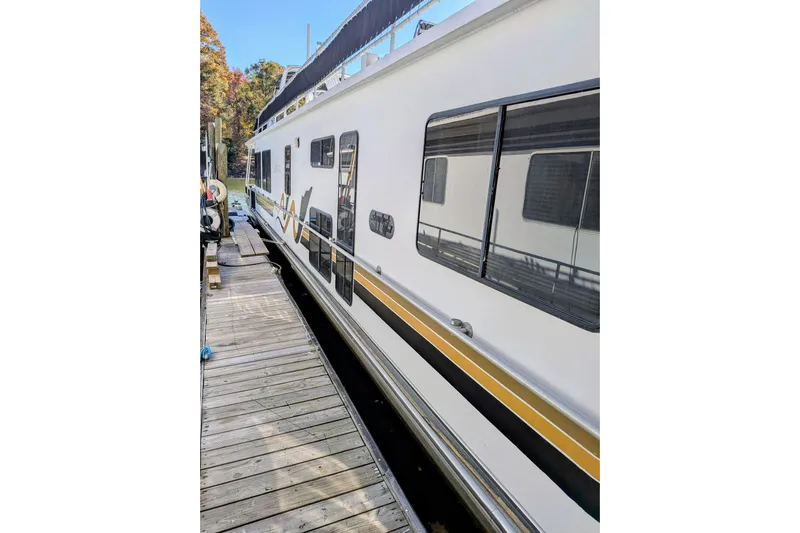  Yacht Photos Pics 1996 Stardust Cruisers houseboat docked, featuring sleek design and large windows.