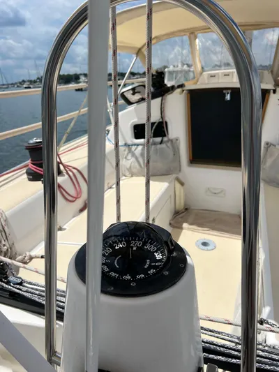 Tern Yacht Photos Pics 2001 J Boats J/120 sailboat cockpit with compass, ropes, and sunny marina view.