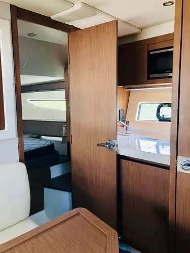  Yacht Photos Pics Interior of 2024 Beneteau 36 Gran Turismo GT yacht with modern kitchen and cozy bedroom.