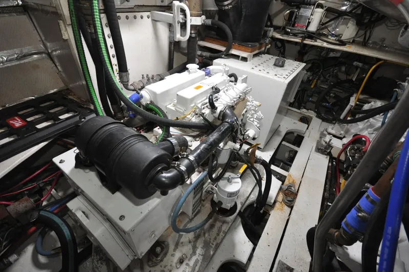 In The Flow Yacht Photos Pics Engine room of 1982 Custom Virpack Steelhull with complex machinery and wiring.