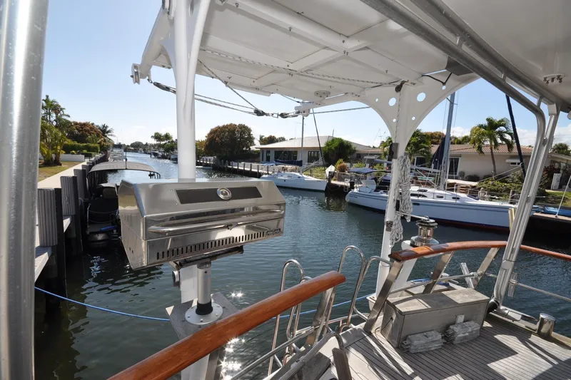 In The Flow Yacht Photos Pics Custom 1982 Virpack Steelhull boat with grill, docked in a scenic canal setting.