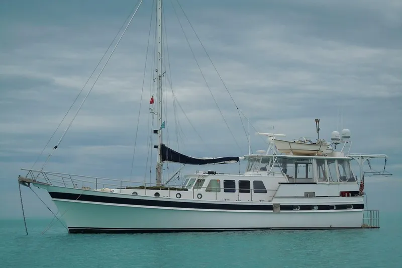 In The Flow Yacht Photos Pics Custom 1982 Virpack Steelhull yacht anchored on calm turquoise waters.