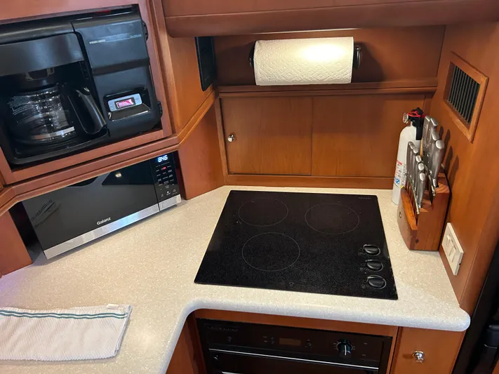 Ps Thank You Yacht Photos Pics 2004 Silverton 39 Motor Yacht kitchen with stove, microwave, and coffee maker.