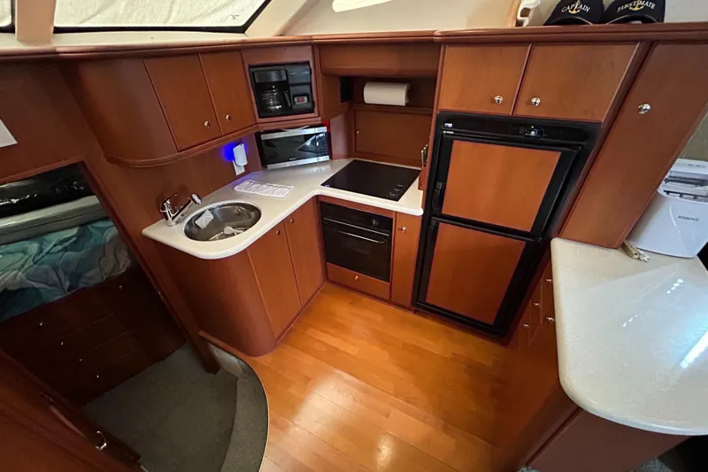 Ps Thank You Yacht Photos Pics 2004 Silverton 39 Motor Yacht kitchen with wood cabinetry and modern appliances.
