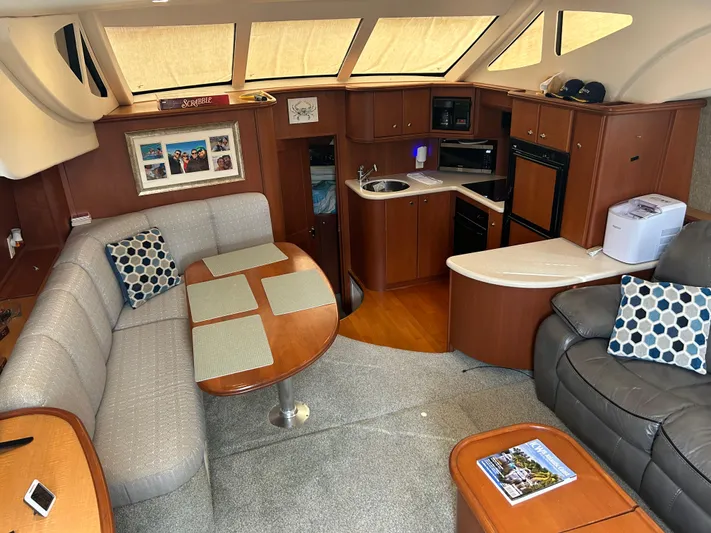 Ps Thank You Yacht Photos Pics Interior of 2004 Silverton 39 Motor Yacht with cozy seating and modern kitchen amenities.