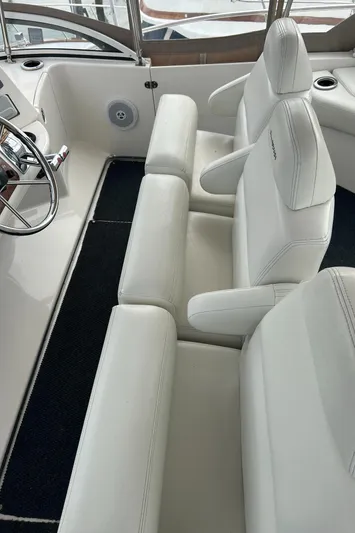 Ps Thank You Yacht Photos Pics 2004 Silverton 39 Motor Yacht interior with white leather seating and steering wheel.