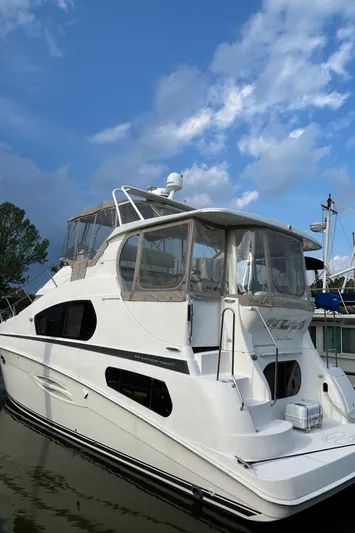 Ps Thank You Yacht Photos Pics 2004 Silverton 39 Motor Yacht docked under a blue sky.