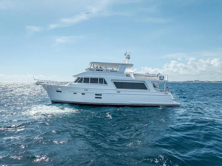 Sunny Seajay Yacht Photos Pics 2022 Hampton 658l Endurance yacht cruising on open sea under clear blue sky.