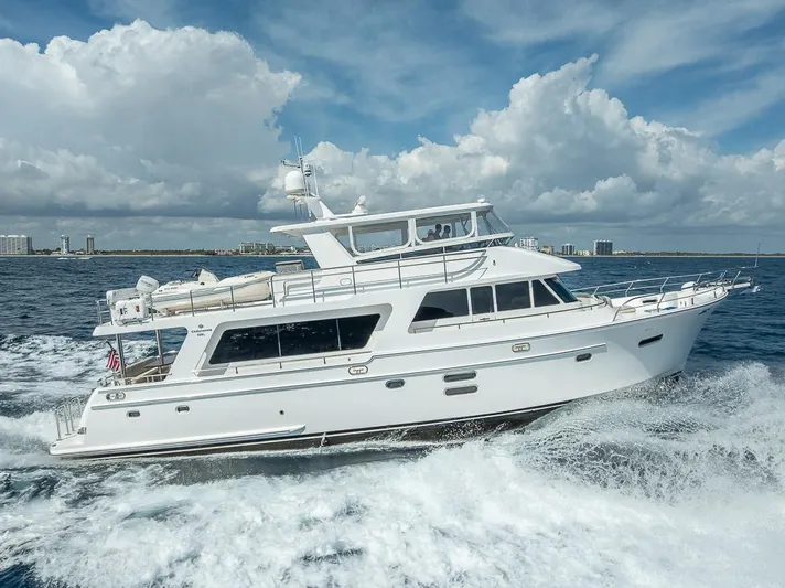 Sunny Seajay Yacht Photos Pics Luxury yacht Hampton 658l Endurance 2022 cruising on open sea under blue sky.