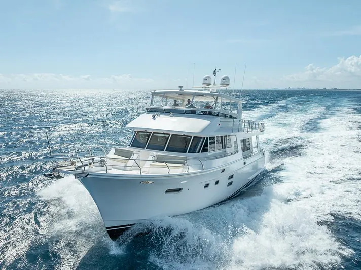 Sunny Seajay Yacht Photos Pics 2022 Hampton 658l Endurance yacht cruising on open sea under clear blue sky.