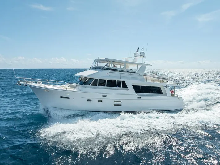 Sunny Seajay Yacht Photos Pics 2022 Hampton 658l Endurance yacht cruising on open sea under clear blue sky.