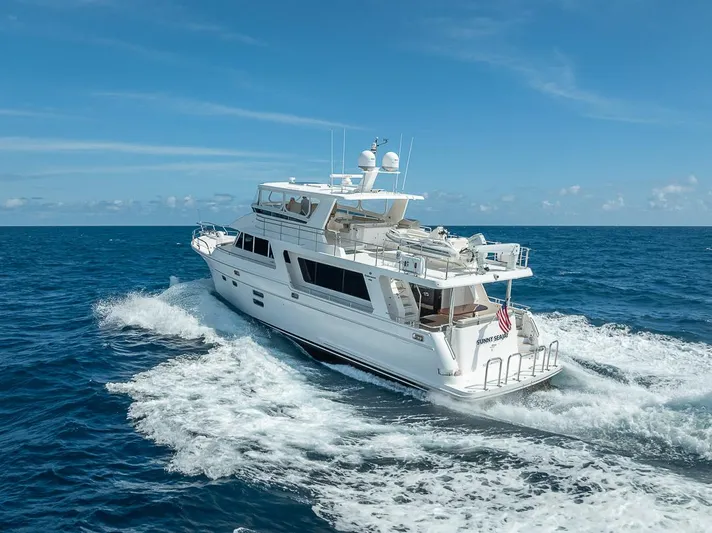 Sunny Seajay Yacht Photos Pics 2022 Hampton 658l Endurance yacht cruising on open ocean under clear blue sky.