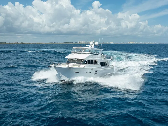 Sunny Seajay Yacht Photos Pics 2022 Hampton 658l Endurance yacht cruising on open ocean under cloudy sky.