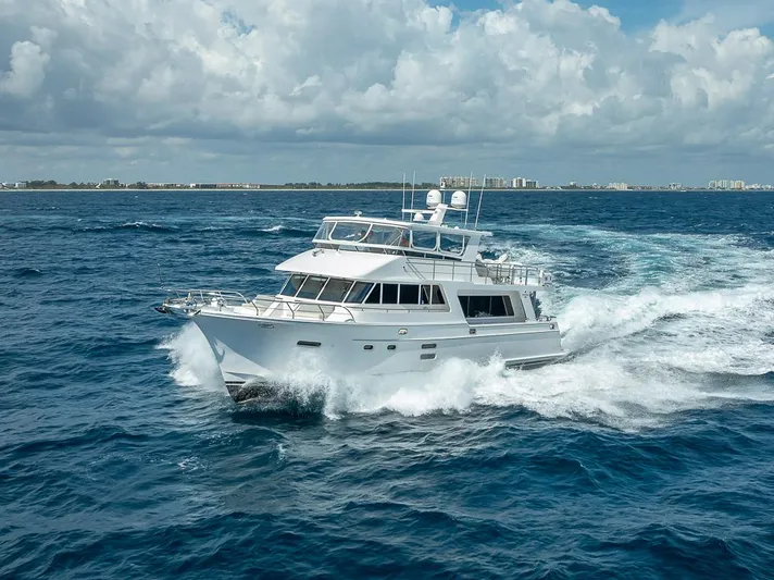 Sunny Seajay Yacht Photos Pics 2022 Hampton 658l Endurance yacht cruising on open ocean under cloudy sky.