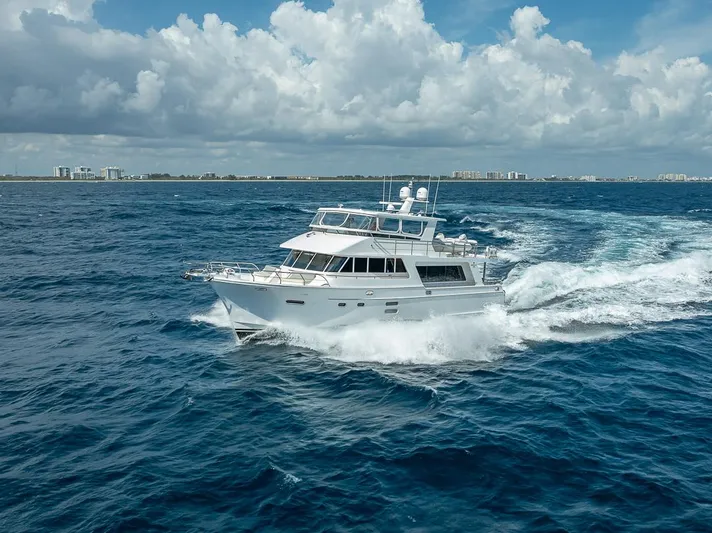 Sunny Seajay Yacht Photos Pics 2022 Hampton 658l Endurance yacht cruising on open ocean under cloudy sky.