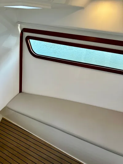 Key East Yacht Photos Pics Interior of 2023 MJM 3 boat with wooden trim and cushioned seating.
