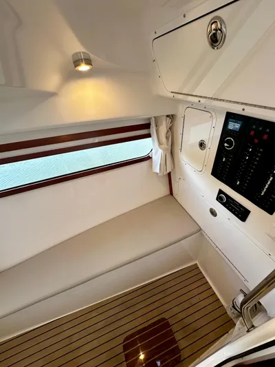 Key East Yacht Photos Pics 2023 MJM 3 boat interior with seating, control panel, and wood flooring.