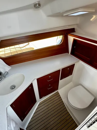 Key East Yacht Photos Pics 2023 MJM 3 yacht bathroom with wooden cabinets and modern fixtures.