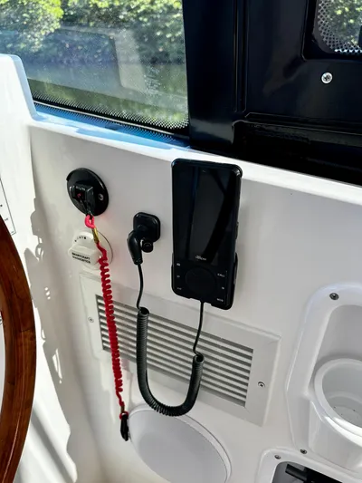 Key East Yacht Photos Pics Boat dashboard with mounted phone, red coiled cord, and speaker on MJM 3, 2023 model.