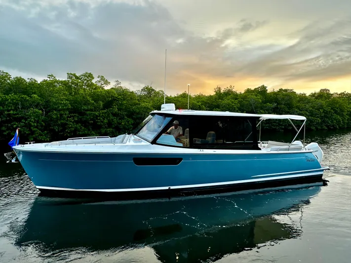 Key East Yacht Photos Pics 2023 MJM 3 boat on calm water at sunset.