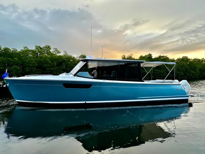 Key East Yacht Photos Pics 2023 MJM 3 boat on calm water at sunset.