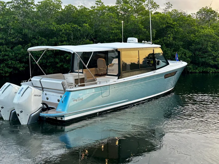 Key East Yacht Photos Pics 2023 MJM 3 boat with twin engines on a calm waterway.