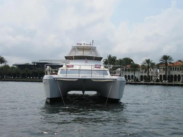 Africa 3 Yacht Photos Pics Africat Marine 420 catamaran, 2008 model, on water near luxury waterfront homes.