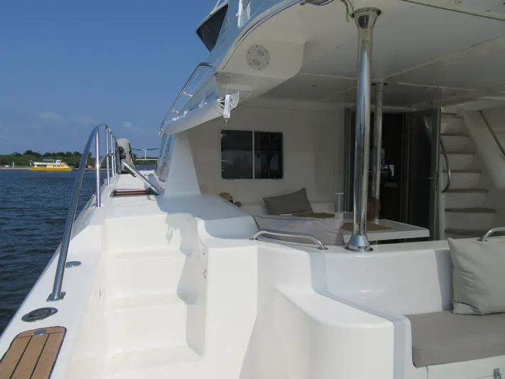 Africa 3 Yacht Photos Pics 2008 Africat Marine 420 yacht, spacious deck with seating, docked by calm waters.