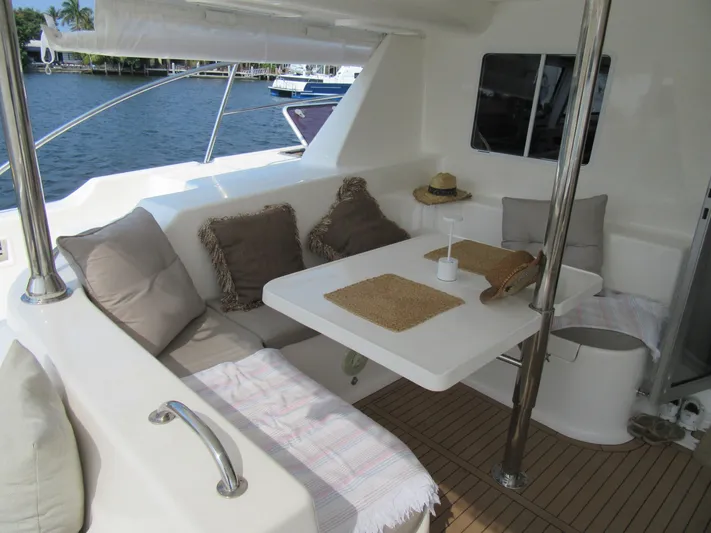 Africa 3 Yacht Photos Pics Cozy seating area on 2008 Africat Marine 420 yacht with cushions and table.