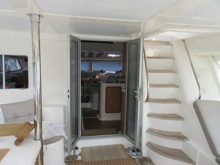 Africa 3 Yacht Photos Pics Interior view of 2008 Africat Marine 420 yacht, featuring stairs and open doors.