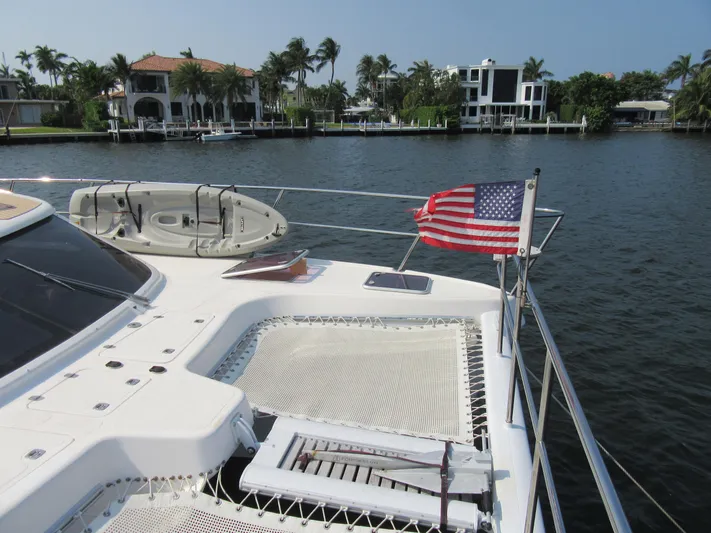 Africa 3 Yacht Photos Pics Africat Marine 420 yacht, 2008 model, with American flag, docked near waterfront homes.