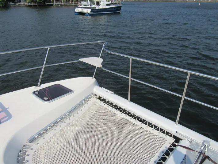 Africa 3 Yacht Photos Pics Africat Marine 420 catamaran, 2008 model, with netting on deck, on calm water.