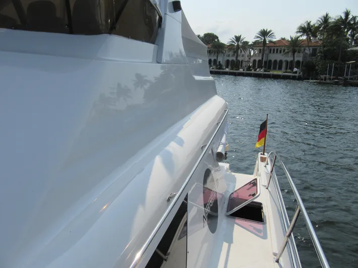 Africa 3 Yacht Photos Pics Africat Marine 420 yacht, 2008 model, docked by waterfront with palm trees and buildings.