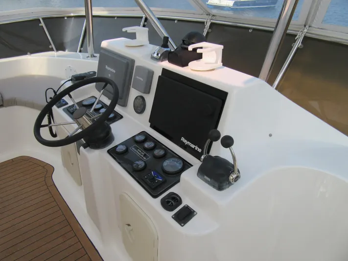 Africa 3 Yacht Photos Pics Africat Marine 420 helm with navigation controls, steering wheel, and electronic displays, 2008 model.