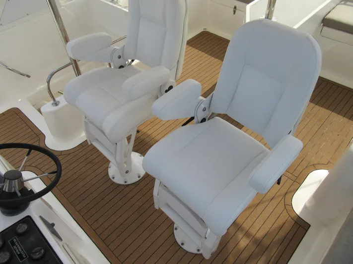 Africa 3 Yacht Photos Pics White captain chairs on Africat Marine 420 yacht, 2008 model, with teak flooring.