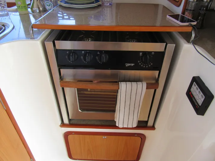 Africa 3 Yacht Photos Pics 2008 Africat Marine 420 yacht kitchen with stainless steel oven and wooden cabinetry.