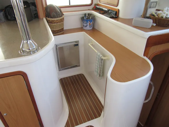 Africa 3 Yacht Photos Pics Africat Marine 420 yacht interior, 2008 model, featuring a compact kitchen area with wood accents.