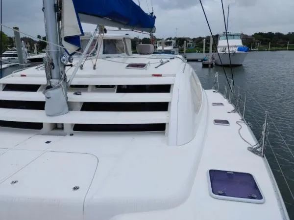 Titan 46 Yacht Photos Pics Sailing catamaran Leopard 46, 2011 model, docked at marina with overcast sky.