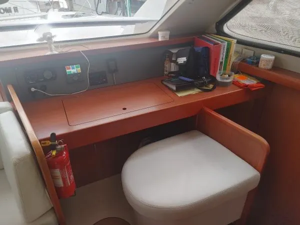 Titan 46 Yacht Photos Pics Navigation station inside 2011 Leopard 46 yacht with desk, chair, and equipment.