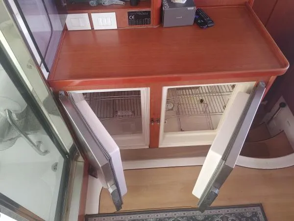 Titan 46 Yacht Photos Pics Wooden cabinet with open mini fridge doors on a Leopard 46 yacht, 2011 model.