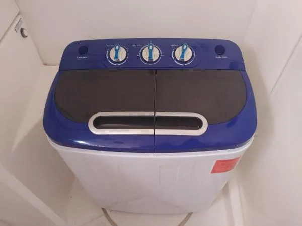 Titan 46 Yacht Photos Pics Top-loading washing machine, Leopard 46 model, 2011, with blue control panel and three dials.